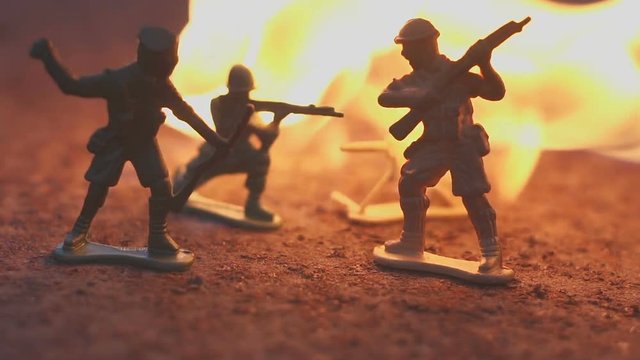 toy soldier in the fire. The model of the battle scene. The concept of the death of war