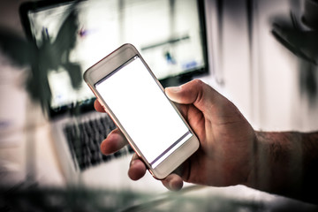 Holding mobile phone.