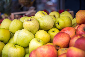 Green and red apples at the food market