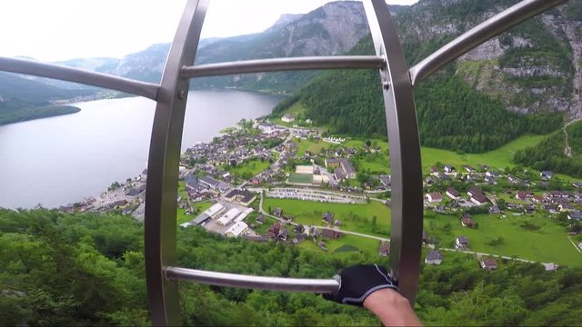 POV - a man climbs up a ladder to a rope at a cliff