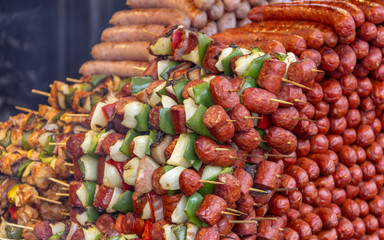various barbecued sausages and meat skewers