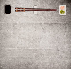 Traditional japanese sushi sticks on rustic concrete background.