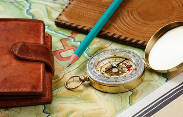 compass wallet and passport on the old map