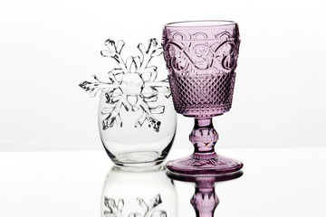 Different empty glasses against white background