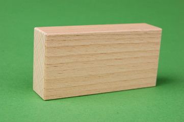 wooden geometric shapes on a green background