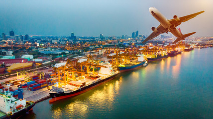 Top view of container ship and aircraft in export and import business and logistics. Shipping cargo to harbor by crane. Aerial view Container Cargo ship and Cargo plane with working crane bridge