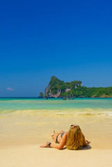 Fototapeta na wymiar woman resting at the tropical beach of Phi Phi Don