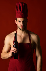 Silhouette of male sommelier which tasting red wine. Wine making. Restaurant. Chef in apron testes wine. Italian style and sommelier concept. Bearded man holds bottle wine.