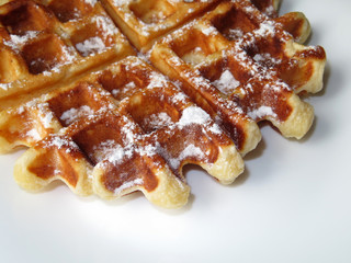 Belgian waffles in a white plate. Homemade breakfast