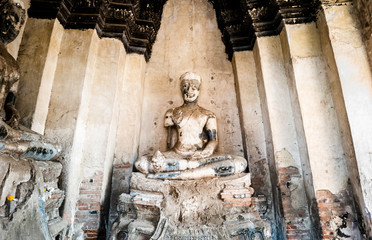 View of old Buddha statue at Wat Chaiwatthanaram which is the ancient Buddhist temple in the Ayutthaya Historical Park, Ayutthaya province, Thailand. 