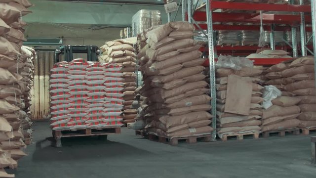 Working autoloader moving goods in industrial warehouse