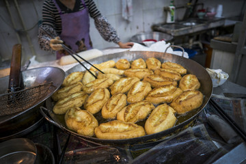 Frying Chinese bread-dough in hot oil.
