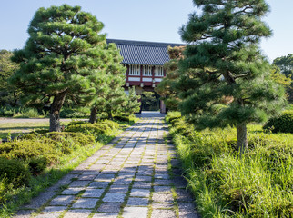 Stone walkway leading through an old gatehouse in Kyoto