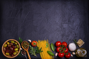 Selection of healthy food. Italian food background with spaghetti, cheese, olives, tomatoes and basil. Slate banner background. View from above, top, flat lay with room for text