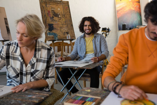 Portrait of man with friends practicing painting