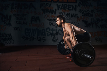 Muscular men lifting deadlift