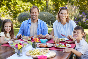 Parents and kids having a lunch together in the garden