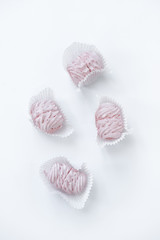 Pink marshmallows, handmade sweets, zephyr, soft confectionery, candy on a light background. Sweet marshmallow.