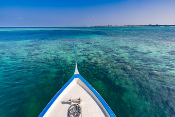 Maldives island lagoon water, clear sea and coral reef, view from Dhoni traditional Maldives boat