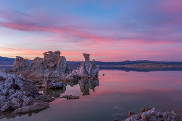 Sunset at Mono lake, California. Bizarre calcareous tufa formation on the smooth water of the lake.