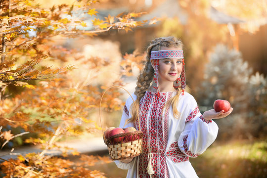 Girl In Russian Folk Costume Holding Apples