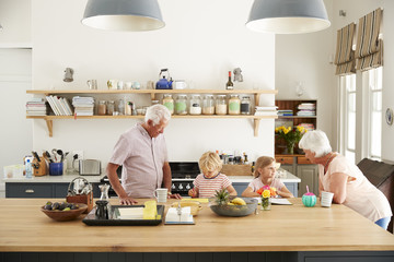 Grandparents and their grandkids talking in the kitchen