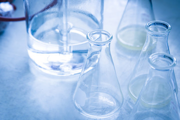 Group of glassware scientific equipment in chemical laboratory, that is a erlenmeyer flask in blue...