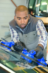 Man fitting new windshield