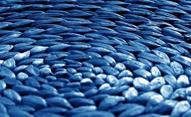 Obraz premium Round straw mat texture with blur effect in navy blue tone.