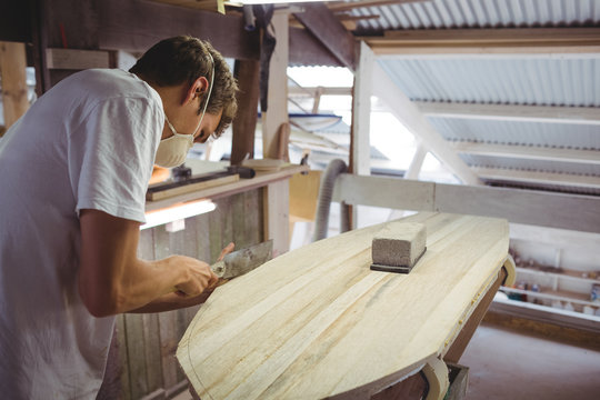 Man making surfboard