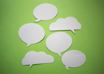 Speech bubbles on green paper background.	