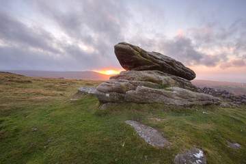 Logan stone on Belstone Tor at sunset Dartmoor Devon Uk © annacurnow