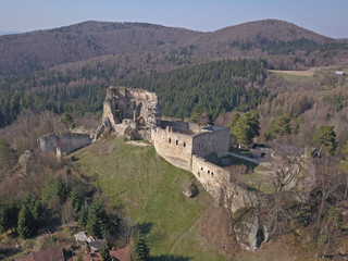 Fototapeta na wymiar Kamenets, near Odjykon, Poland -april 8, 2018: Ancient ruins of a medieval castle against the backdrop of a natural landscape of the central strip of central Europe. View of drone. Panorama of fly.