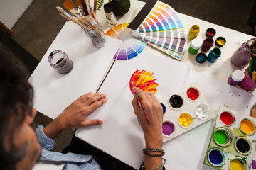 Man painting in drawing book