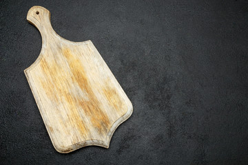 decorative wooden serving or cutting board on concrete background