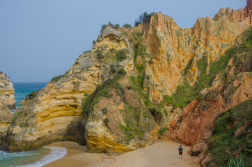 People at sandy Praia do Camilo beach near Lagos, Portugal.