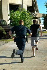 Policeman chasing after suspect man
