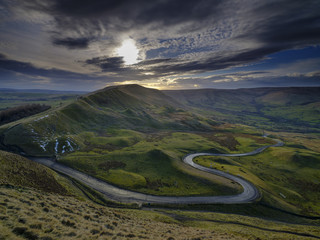 Spring Evening Sunset on Mam Tor with interesting sky looking towards RushUp Ridge with a view over the winding road from Winnats Pass to Edale © Julian Gazzard