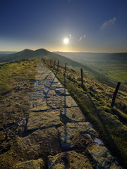 Spring Sunrise on Mam Tor overlooking Edale and the Hope Valley after a clear night with a light dusting of snow