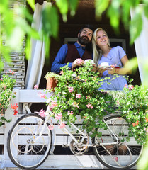 Woman and man with happy faces have date on terrace