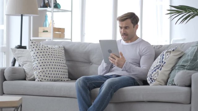 Tense Frustrated Man Reaction, while Using Tablet
