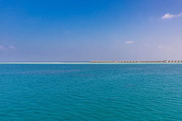 Luxury water villas and infinity blue sea. Summer luxurious travel destination