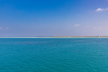 Fototapeta premium Luxury water villas and infinity blue sea. Summer luxurious travel destination