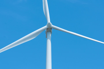 Wind turbines generating electricity with blue sky