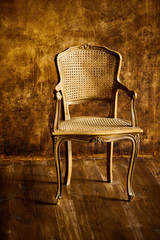 old chair on a brown wall background.