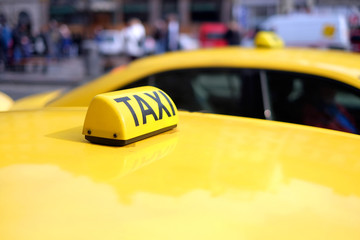 Sign taxi close-up on city background.