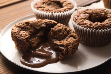 Chocolate lava muffins on dark wooden background with