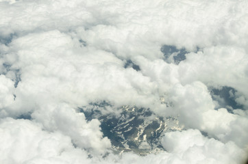 Aerial shooting from an airplane flying over the ground mountains in Turkey