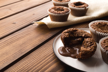 Chocolate lava muffins on dark wooden background with