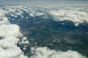Aerial shooting from an airplane flying over the ground mountains in Turkey
